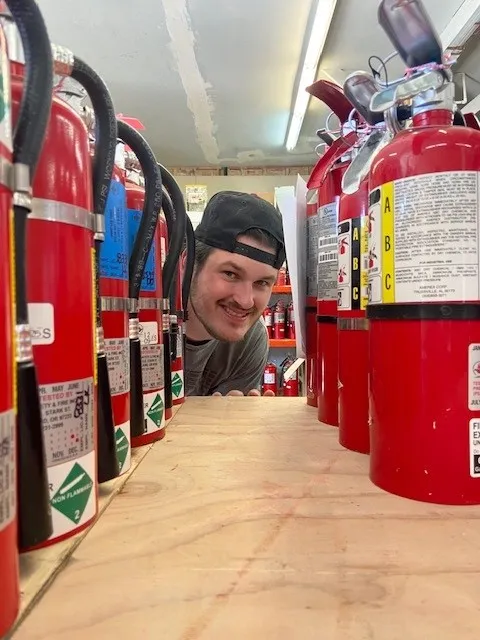 Image of technician with fire extinguisher