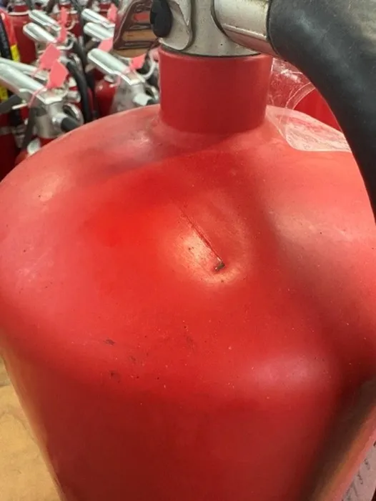 Fire extinguisher with dent