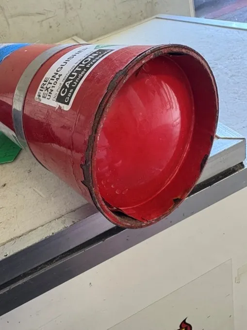 Fire extinguisher with rust damage